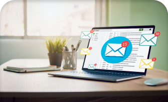 Laptop showing email marketing statistics with email icons on the screen.