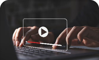 Hands typing on a keyboard with a video play button overlay.